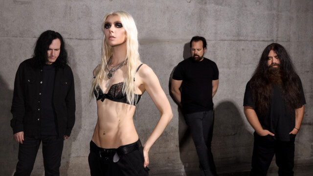 The Pretty Reckelss stehen vor einer Betonwand