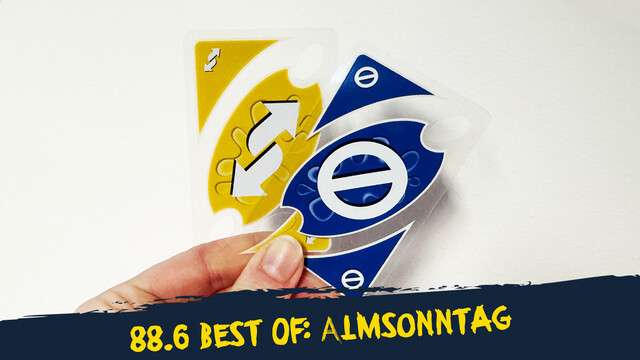 eine gelbe Richtungswechsel- und eine blaue Stopp-Unokarte vor einer weißen Wand